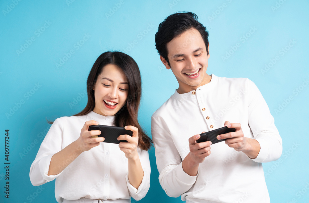 Portrait of young couple using phone on background Portrait of young couple using phone on background