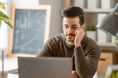 man working on a laptop at home.