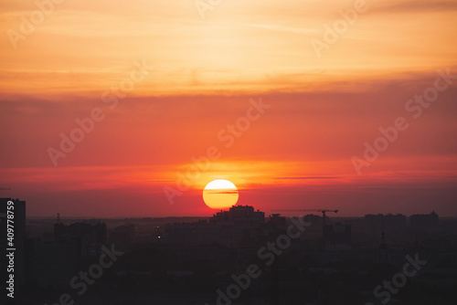Obraz na płótnie Beautiful orange sunset over the city of Ryazan in summer. Sunrise over the city in the fog in summer w salonie