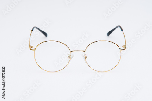 Fashion sunglasses golden frames on white background.