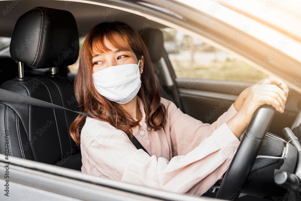 Asian woman beautiful attractive driving car vehicle traveling wearing protective face mask protection safety during coronavirus covid-19 outdoor curfew pandemic, dust air traffic pollution congestion