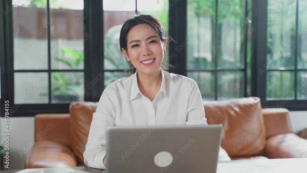 Asian businesswoman working from home, making video conference meeting Asian businesswoman working from home, making video conference meeting