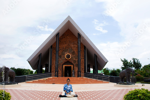 Travelers thai women visit respect praying and take photo with Museum of Ajahn Luang Ta Maha Bua Mahathera at Wat Pa Baan Taad or Ban Tat forest temple on November 15, 2020 in Udon Thani, Thailand photo
