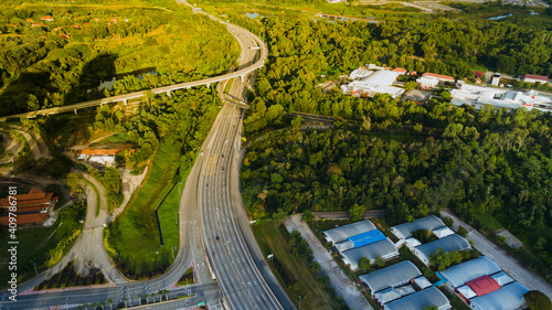 Aerial View of highway and rain forest during light and shadow.