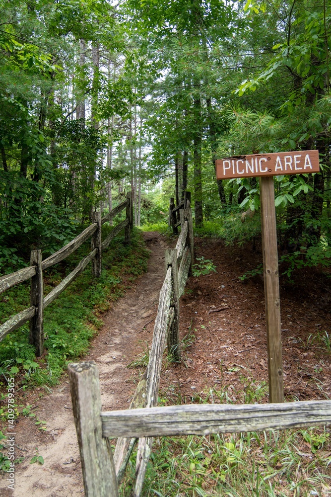 recreational picnic area direction sign and path to the woods