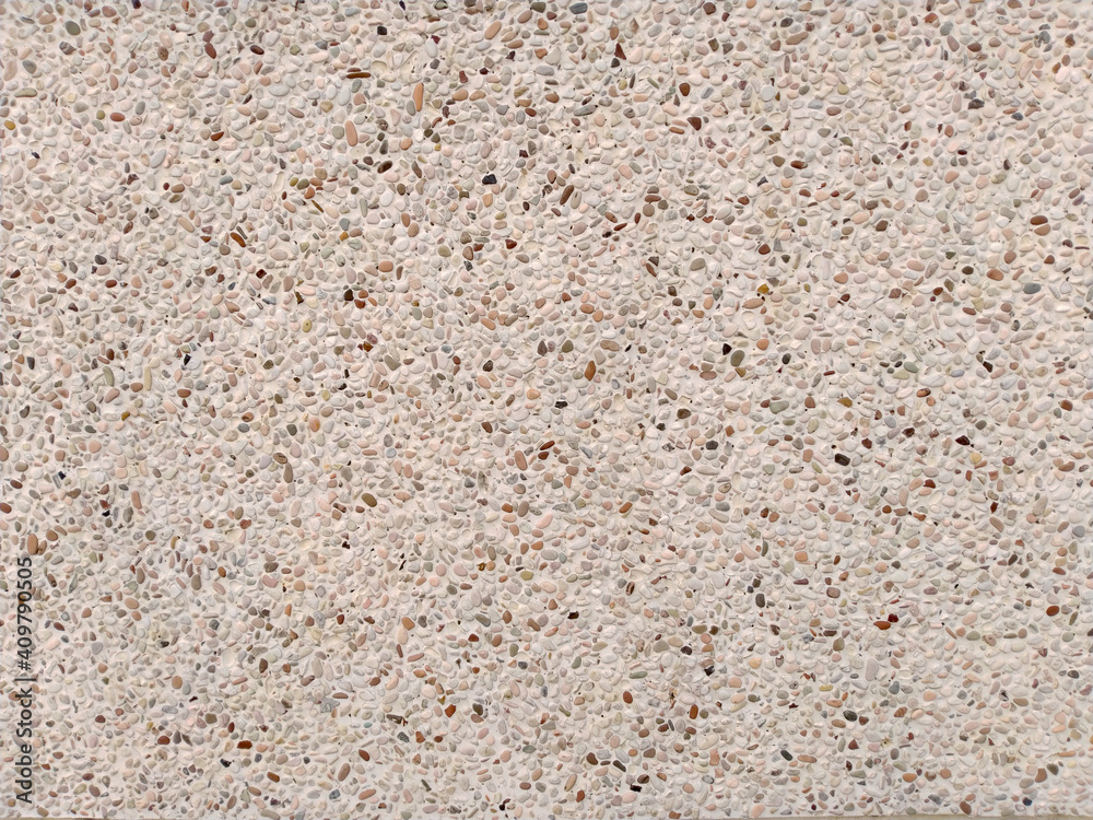 Tiny pebbles on white wall, close lightly pebble background surface Tiny pebbles on white wall, close lightly pebble background surface