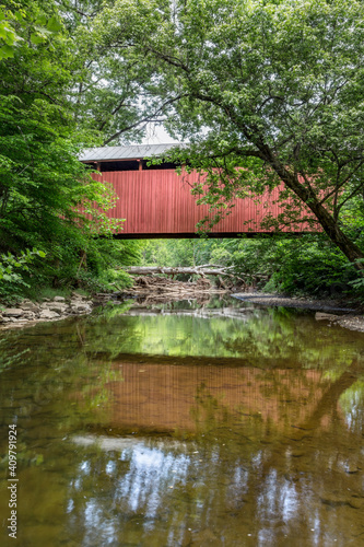Built in 1891, the historic red Fletcher Covered Bridge crosses Tenmile Creek near Marshville in Harrison County, West Virginia. photo