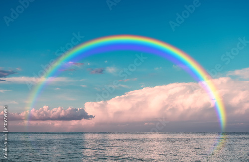 Beautiful view of sea with clouds and rainbow in sky on summer day © Pixel-Shot