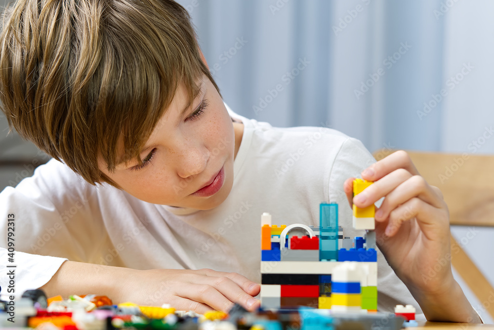 young boy playing with plastic construction toys at home. young boy playing with plastic construction toys at home.
