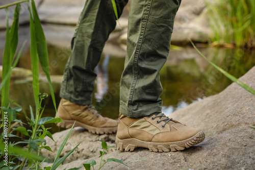 Young male tourist near river in countryside