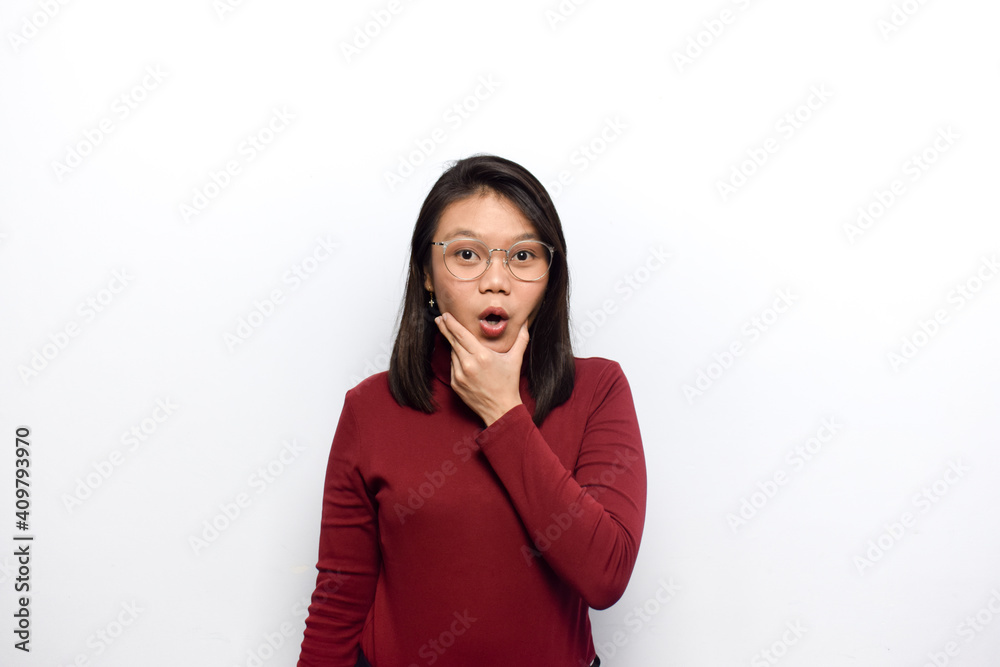 Hand on chin with surprise expression of Young beautiful asian women dress red shirt isolated on white background