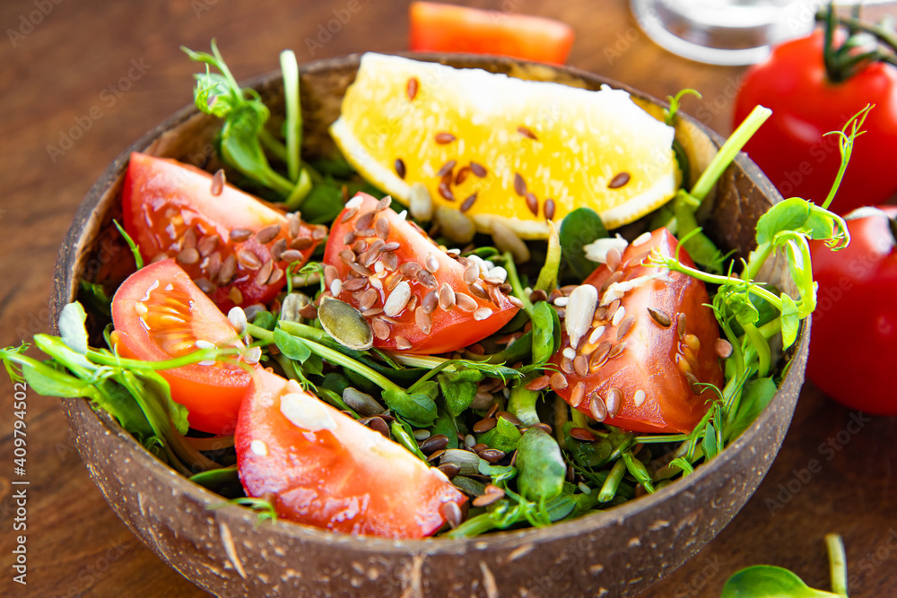  Healthy microgreen salad with tomatoes and seeds close-up