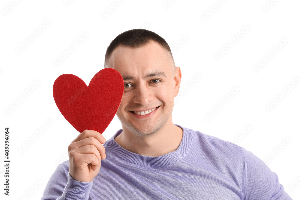 Young man with red heart on white background. Valentine's Day celebration Young man with red heart on white background. Valentine's Day celebration
