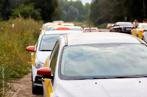 Queue of white taxi cars in Russia