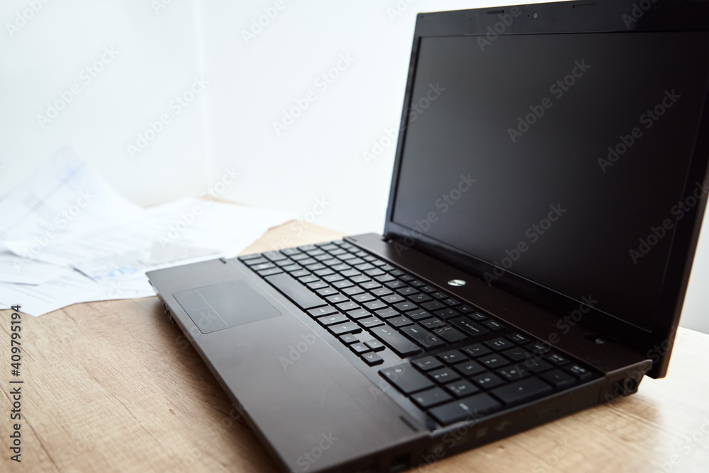 Freelancer home workplace. Laptop on table in office interior. Online job and remote work. Freelancer home workplace. Laptop on table in office interior. Online job and remote work.