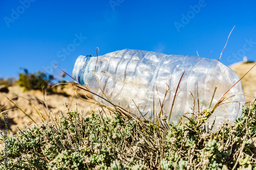 Plastic empty water bottle abandoned on nature