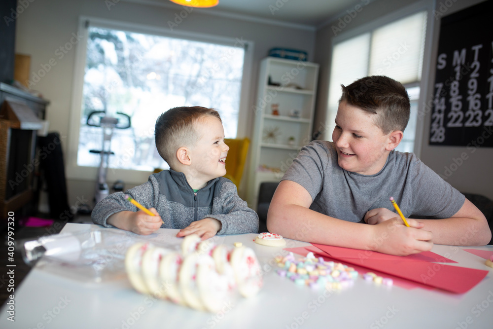 © Gemütlichkeit - sister helping brother's write valentine's day notes