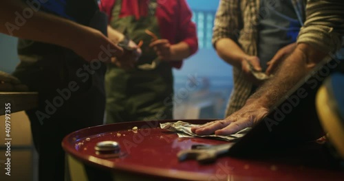 Crop men betting money while watching match