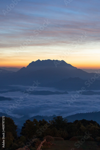 mountain and sea of fog sunrise surrounded with mountain and forest at huai nam dang national park chiang mai, thailand