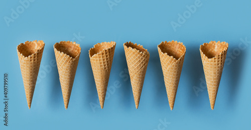Ice cream cones levitate over blue background