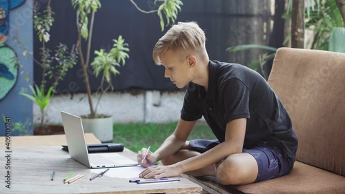 Teenager studying in online school