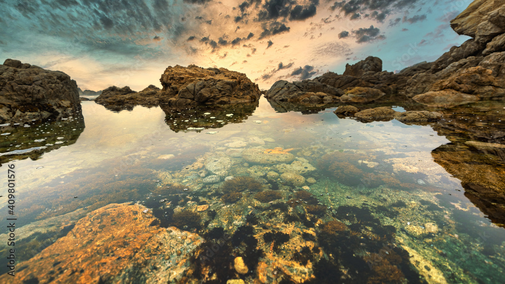 Beautiful seascape, ocean views, rocky coast, sunlight on the horizon. Composition of nature. Sunset scenery background. Cloudy sky. Water Reflection. California Seashore. Beautiful seascape, ocean views, rocky coast, sunlight on the horizon. Composition of nature. Sunset scenery background. Cloudy sky. Water Reflection. California Seashore.