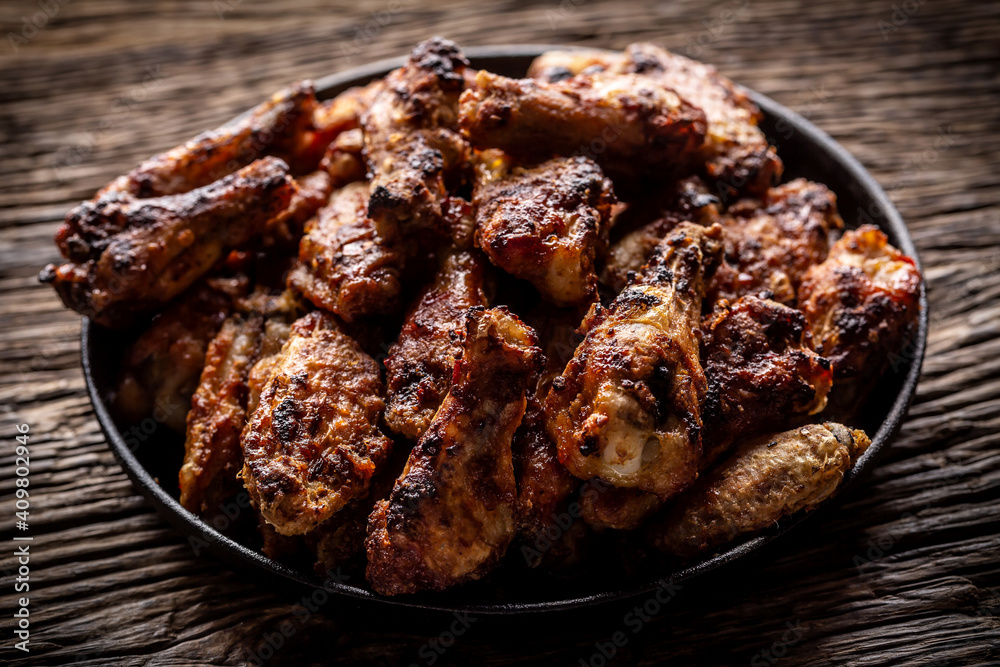 Chicken wings barbeque in a cast iron baking dish