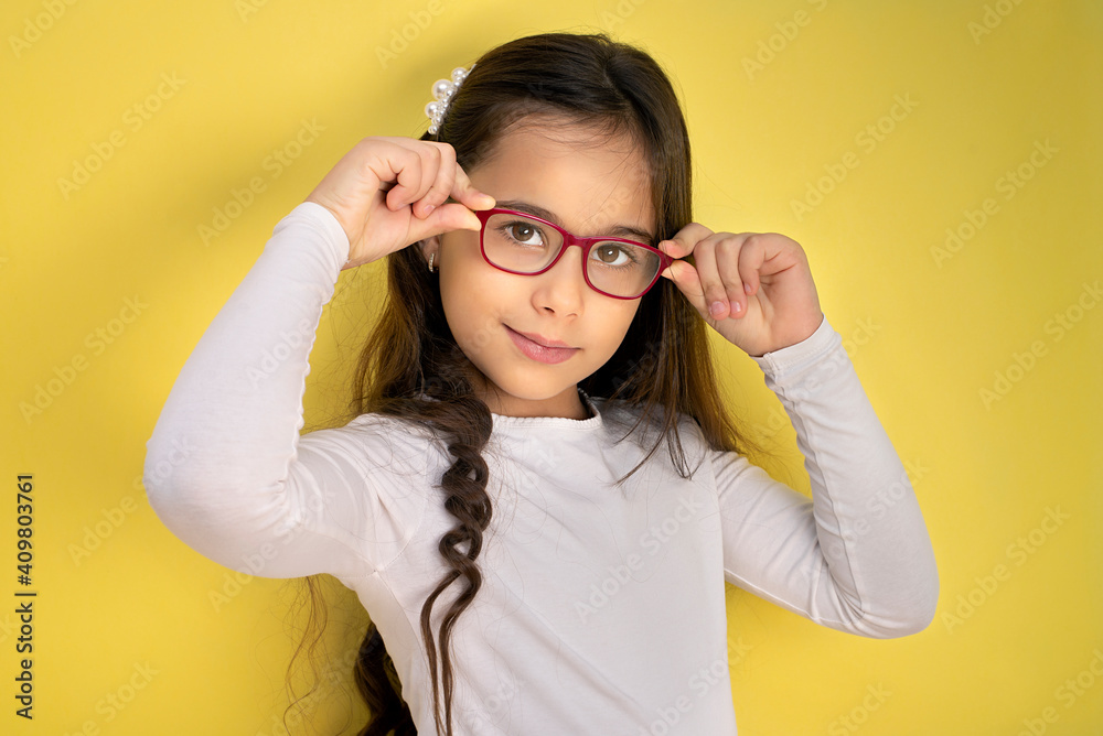 Funny child girl in glasses on colored background Funny child girl in glasses on colored background