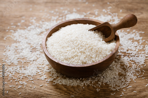 raw white rice on a wooden board
