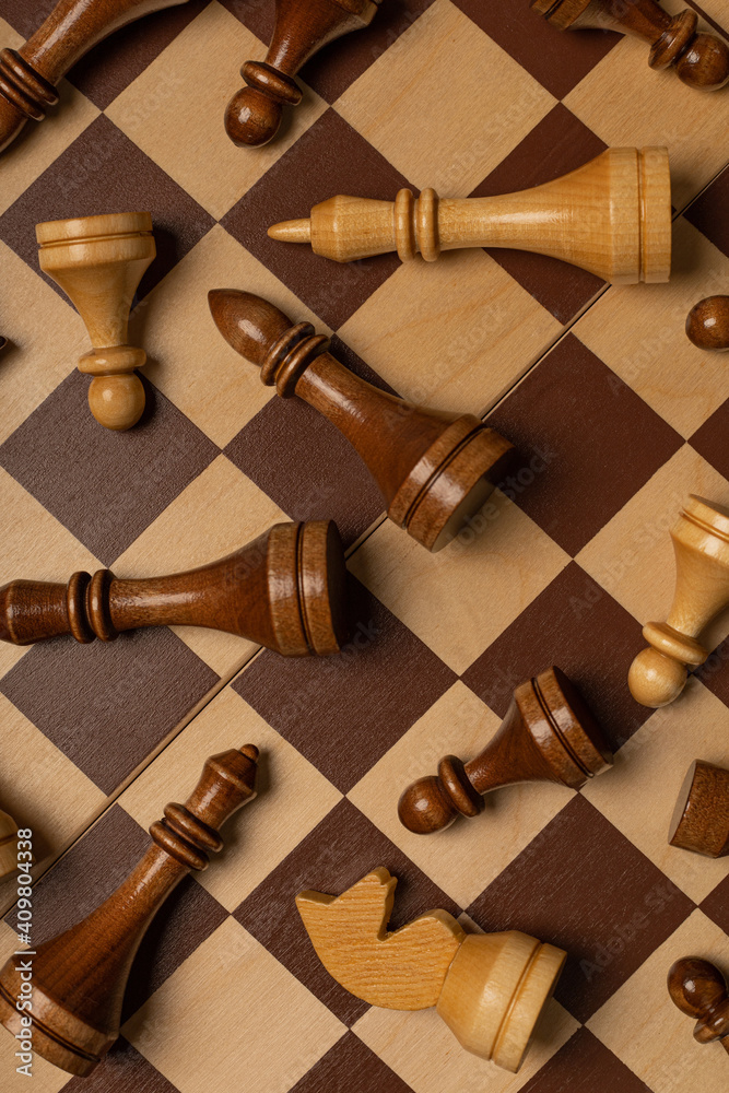 Chess pieces are scattered chaotically on a chessboard Chess pieces are scattered chaotically on a chessboard