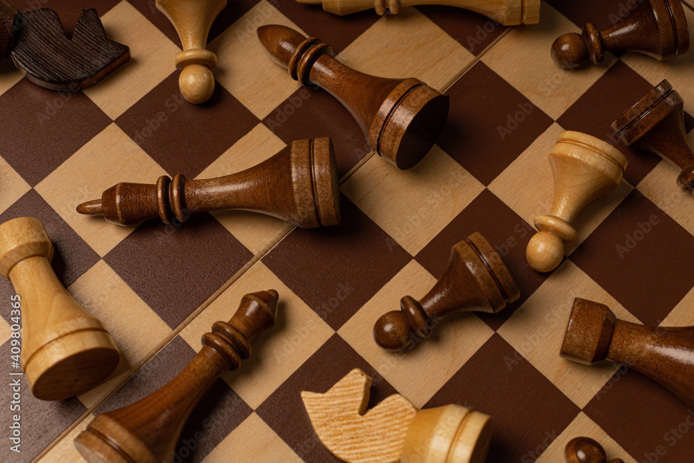 Chess pieces are scattered chaotically on a chessboard Chess pieces are scattered chaotically on a chessboard