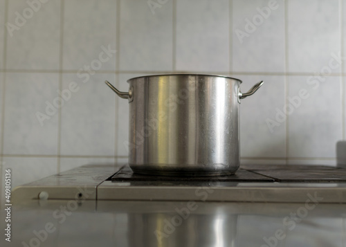metal pot on the stove top, school kitchen, eat cooking