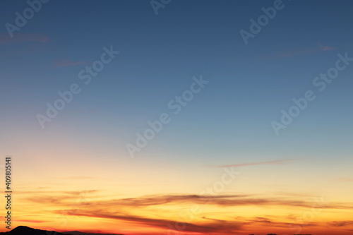 Heaven at early morning with copy space. Sunset  sunrise backdrop.Predawn clear sky with orange horizon and blue atmosphere. Smooth orange blue gradient of dawn sky.