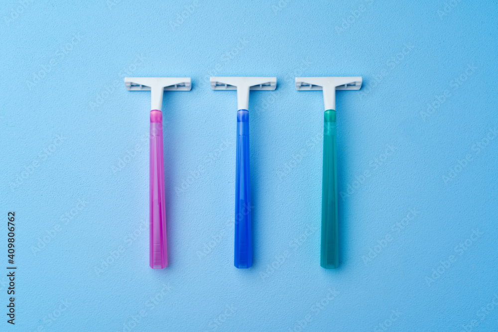 Set of disposable razors for women on blue background Set of disposable razors for women on blue background