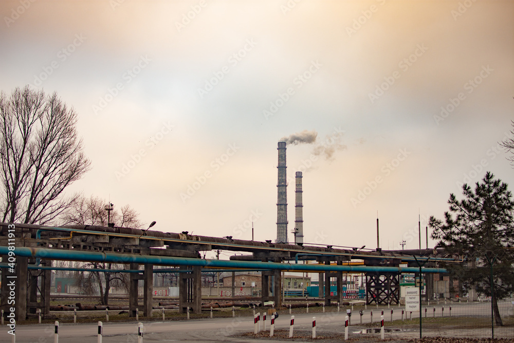 Industrial zone with a large two pipes smoke is poured from the factory pipe. Pollution of the environment. High quality photo Industrial zone with a large two pipes smoke is poured from the factory pipe. Pollution of the environment. High quality photo