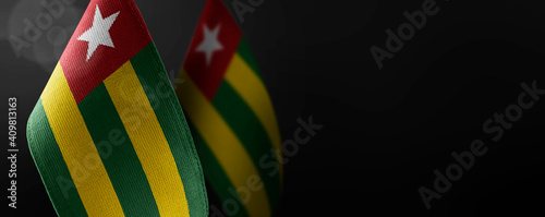 Canvas Print Small national flags of the Togo on a dark background