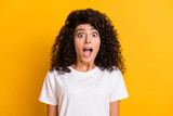 Photo of young beautiful shocked amazed surprised girl with open mouth wear white t-shirt isolated on yellow color background