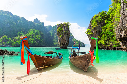 Travel photo of James Bond island with thai traditional wooden longtail boat and beautiful sand beach in Phang Nga bay, Thailand. © preto_perola