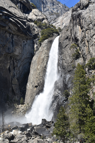 Canvas Print Vertical view of a massive granite wall with a waterfall in Yosemite Valley, Cal