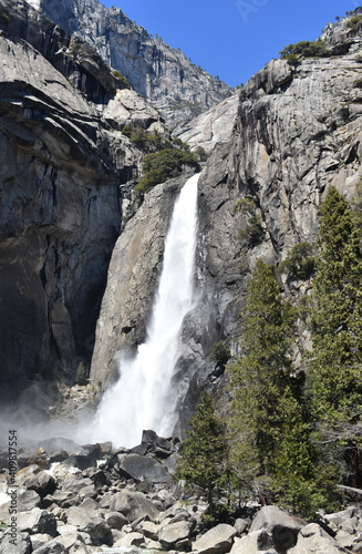 Canvas Print Vertical view of a massive granite wall with a waterfall in Yosemite Valley, Cal