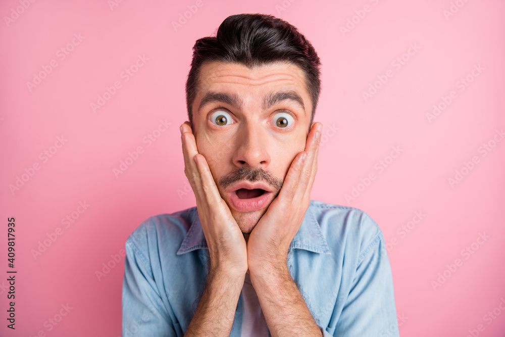 Close-up portrait of worried nervous frustrated guy incredible news reaction isolated over pink pastel color background Close-up portrait of worried nervous frustrated guy incredible news reaction isolated over pink pastel color background