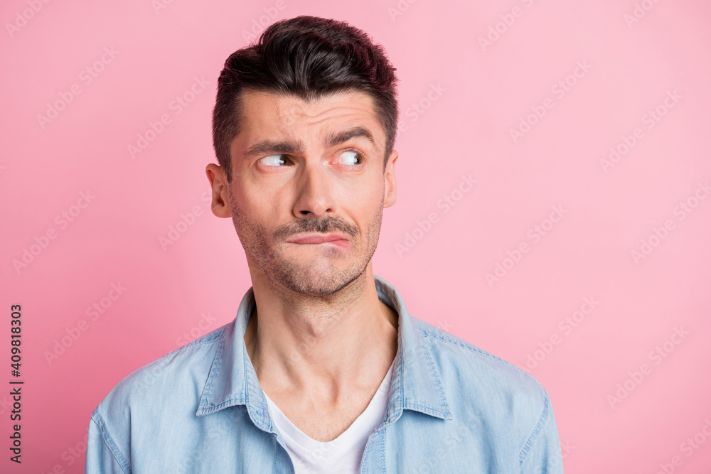 Photo of displeased brunette young man look empty space bite teeth lips isolated on pastel pink color background - obrazy, fototapety, plakaty 