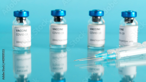Coronavirus vaccine vial with reflection. Covid-19 vaccination with vaccine glass bottles and syringe injection tool for corona immunization treatment. Vaccine against the pandemic. 