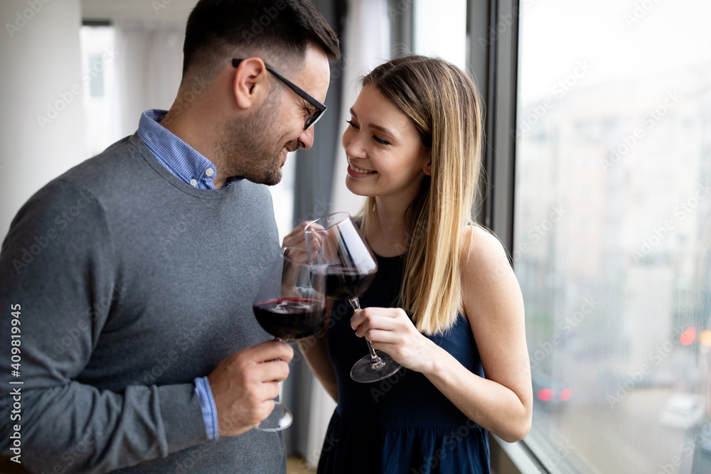 Cheerful happy couple in love drinking wine and having romantic date Cheerful happy couple in love drinking wine and having romantic date
