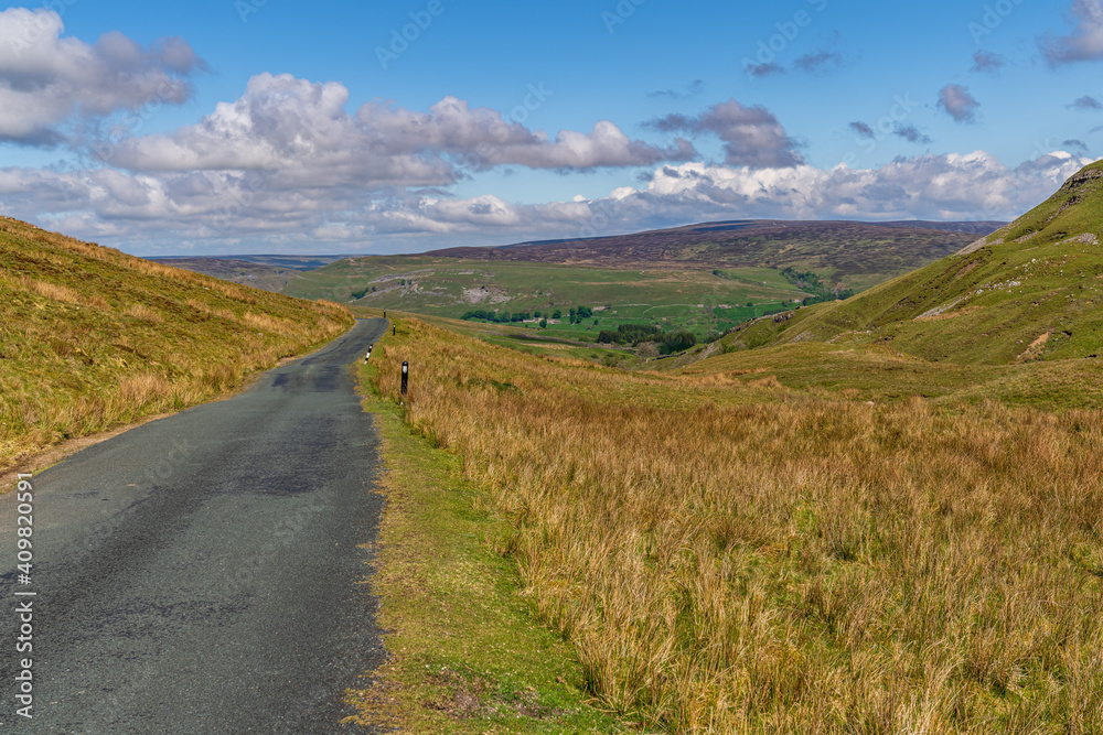 Rural road in the Yorkshire Dales near Askrigg, North Yorkshire, England, UK