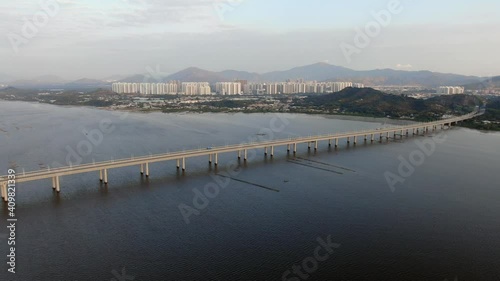 Wallpaper Mural Hong Kong Shenzhen Bay Bridge with Tin Shui Wai buildings in the horizon and Fish and Oyster cultivation pools, Aerial view. Torontodigital.ca