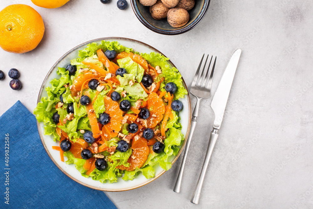 Fresh salad with blueberries, tangerines, carrots and walnuts. Fresh salad with blueberries, tangerines, carrots and walnuts.