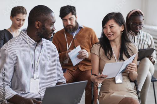 Fotografija Multi-ethnic group of people in audience at business conference focus on smiling
