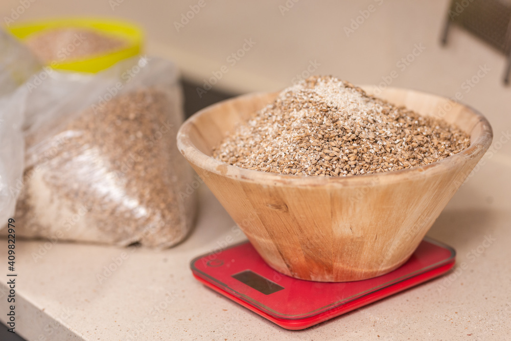 man weighs malt for brewing beer on scale man weighs malt for brewing beer on scale