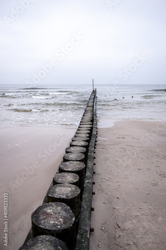 seaside landscape of the baltic sea on a calm day with a wooden breakwater